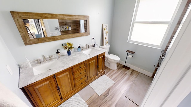 bathroom featuring vanity, toilet, and hardwood / wood-style flooring