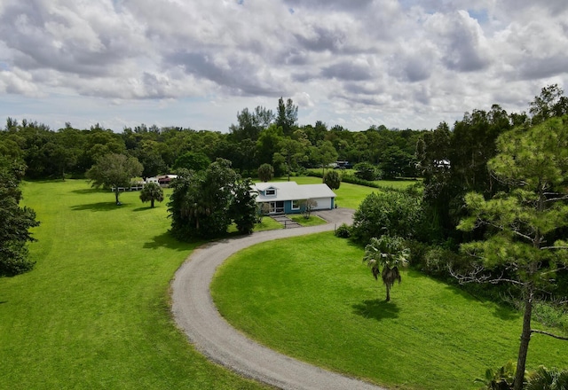 view of community featuring a yard and a rural view