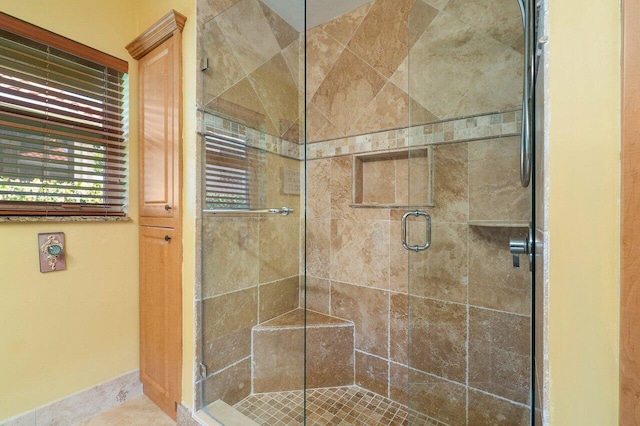 bathroom with a shower with door