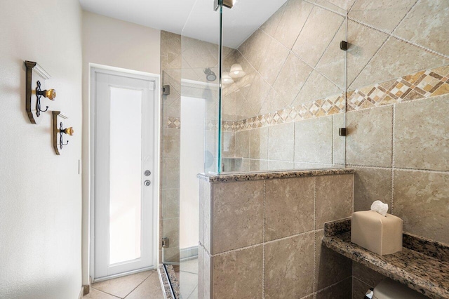 bathroom featuring walk in shower and tile patterned flooring