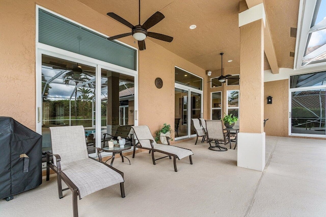 view of patio / terrace with a lanai, grilling area, and ceiling fan