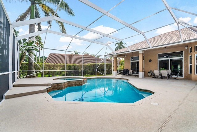 view of pool with ceiling fan, glass enclosure, an in ground hot tub, and a patio area