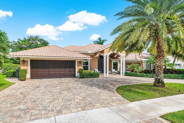 mediterranean / spanish home featuring a garage