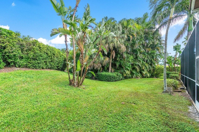 view of yard featuring glass enclosure