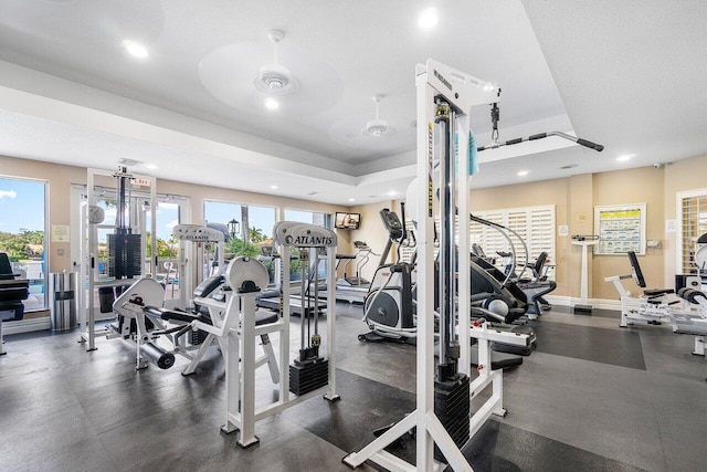 workout area featuring a textured ceiling, a healthy amount of sunlight, and ceiling fan