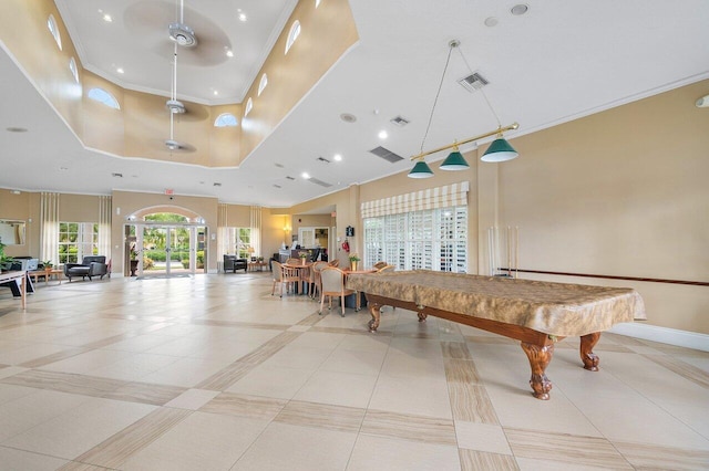 game room with a high ceiling, ceiling fan, ornamental molding, and billiards