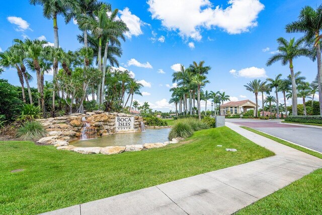 view of home's community featuring a water view and a yard