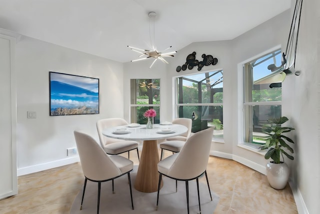 dining space with lofted ceiling and an inviting chandelier