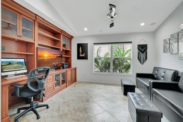 home office with light tile patterned flooring and vaulted ceiling