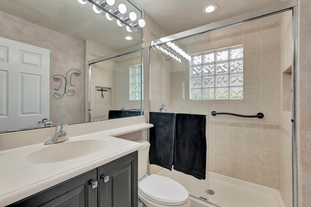 bathroom with vanity, toilet, and walk in shower