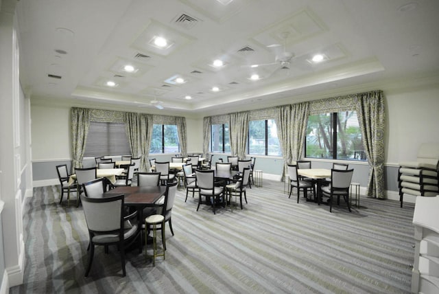 carpeted dining room featuring ornamental molding, coffered ceiling, and ceiling fan