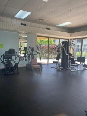 gym with a paneled ceiling