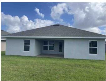 rear view of house with a lawn