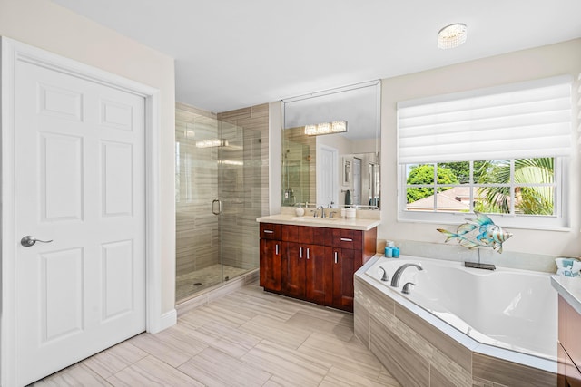 bathroom featuring vanity and shower with separate bathtub