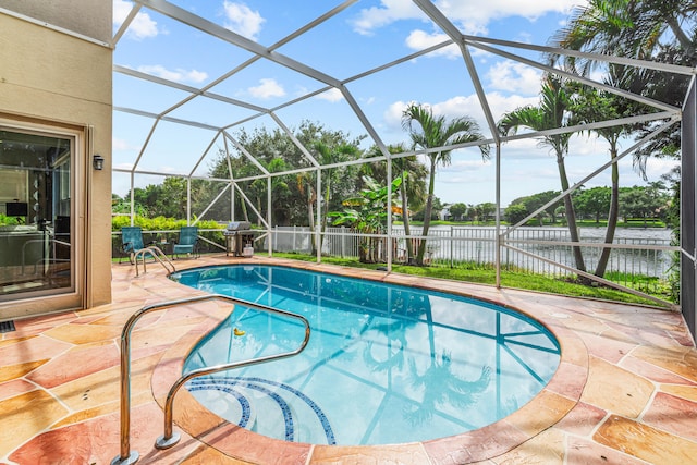 view of swimming pool with glass enclosure, a water view, and a patio