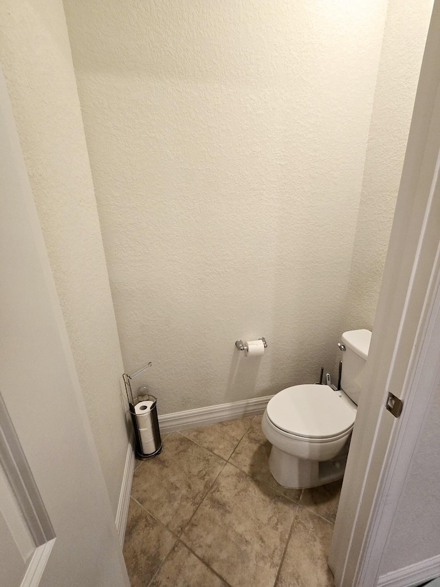 bathroom with tile patterned flooring and toilet