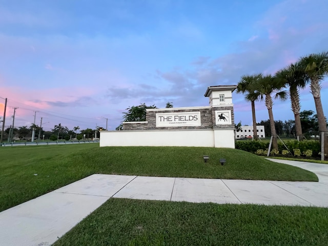 community sign featuring a lawn