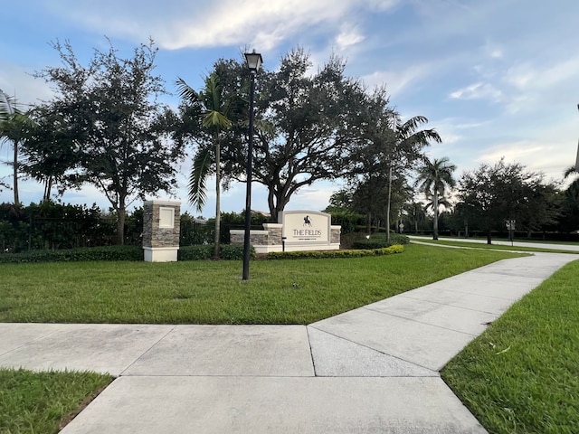 view of property's community with a yard