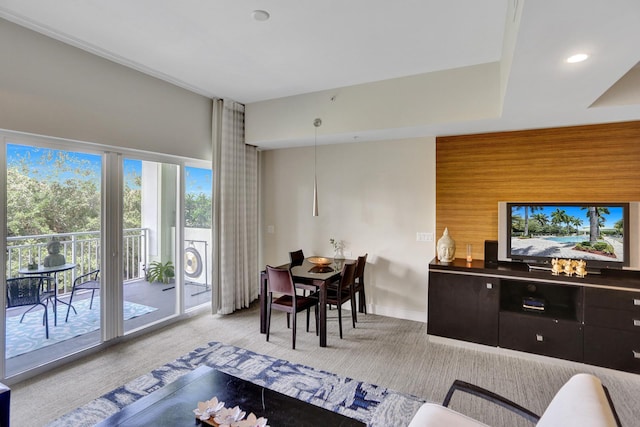 living room featuring wooden walls and light colored carpet