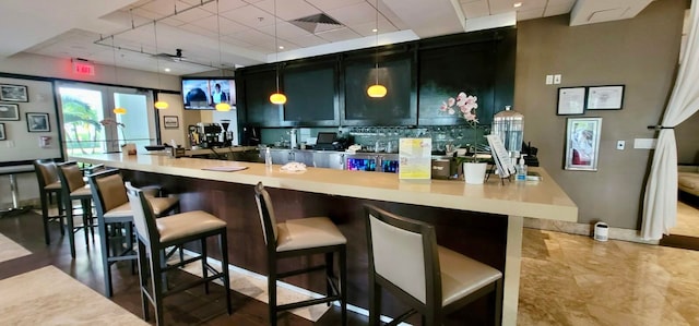 bar featuring hanging light fixtures and ceiling fan