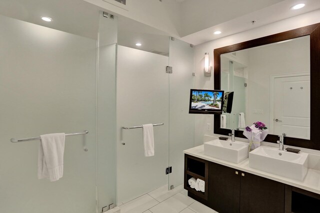 bathroom with vanity, tile patterned flooring, and an enclosed shower