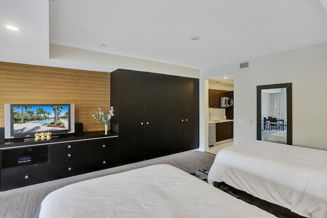 carpeted bedroom featuring ensuite bath