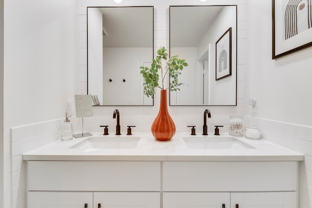 bathroom featuring vanity and decorative backsplash