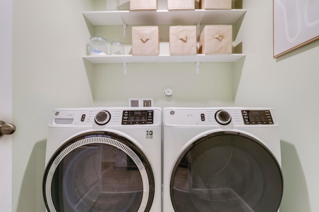 clothes washing area featuring washer and clothes dryer