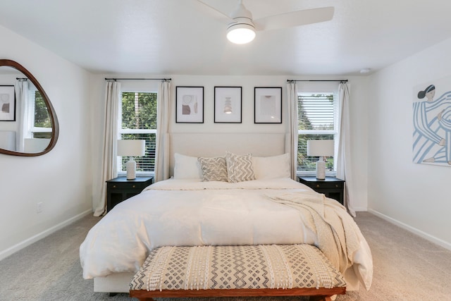 bedroom with ceiling fan, carpet flooring, and multiple windows