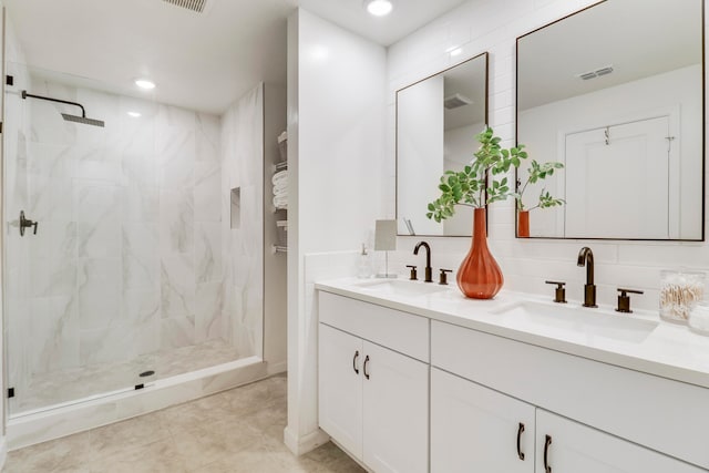 bathroom featuring vanity, a tile shower, tasteful backsplash, and tile patterned flooring