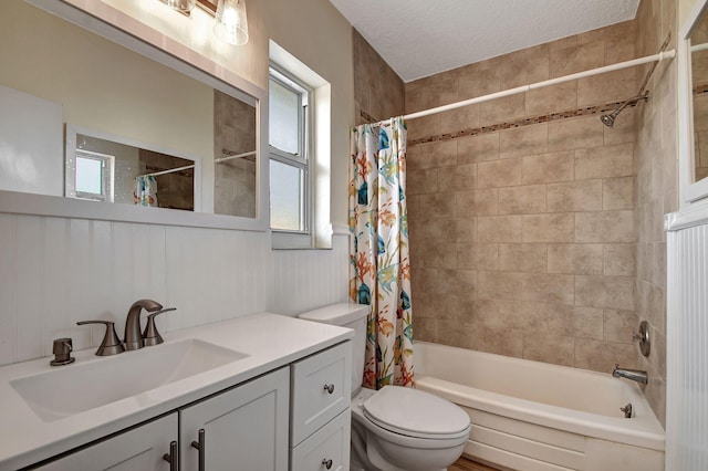 full bathroom with shower / bath combination with curtain, a textured ceiling, vanity, and toilet