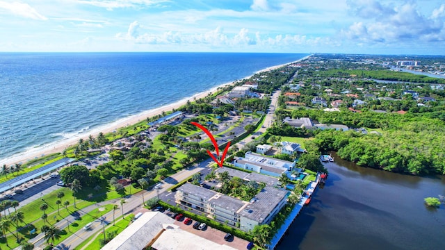 bird's eye view with a water view and a beach view