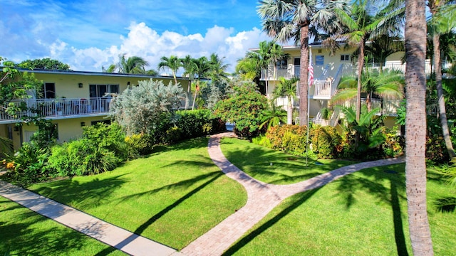 view of home's community with a yard