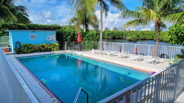 view of swimming pool featuring a water view