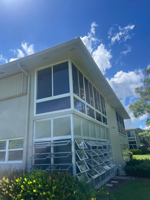 view of side of property with a sunroom