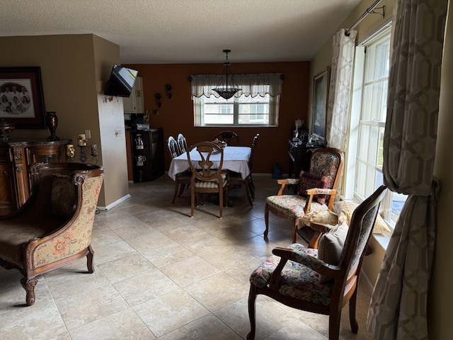 tiled living room with ceiling fan and a textured ceiling