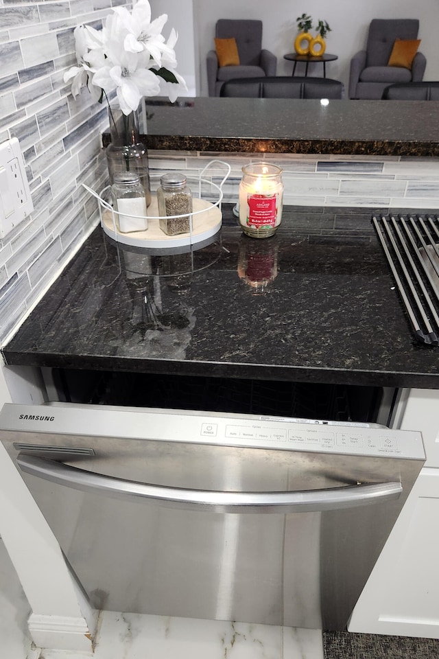 details featuring tasteful backsplash and stainless steel dishwasher