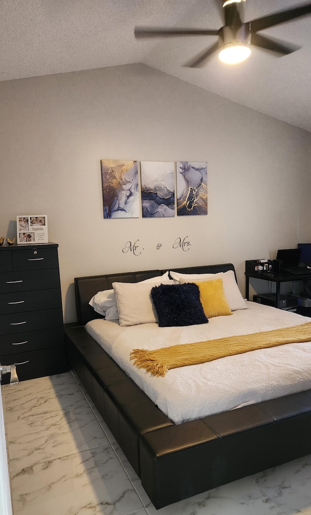 bedroom with ceiling fan, a textured ceiling, and lofted ceiling