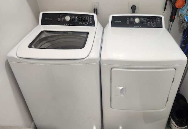 clothes washing area featuring washer and clothes dryer