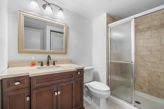 bathroom with tile patterned floors, a shower with shower door, vanity, and toilet