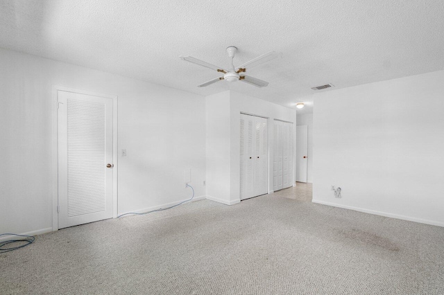 spare room featuring a textured ceiling and ceiling fan