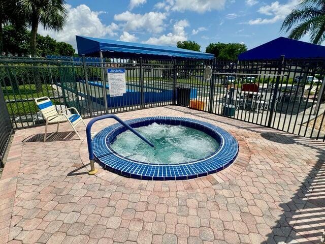 view of swimming pool with a patio and a community hot tub