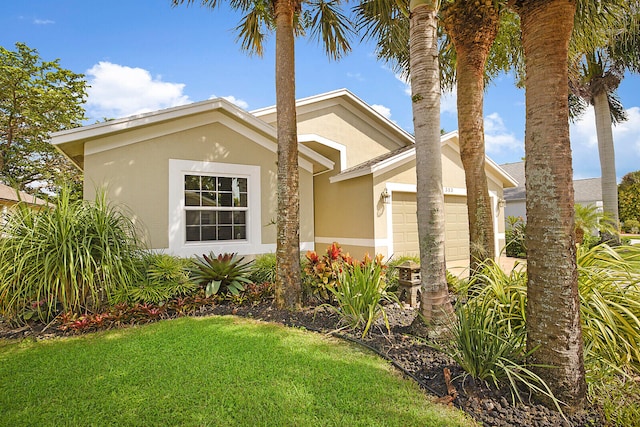 view of front of property with a garage and a front lawn