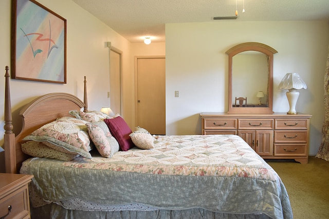 bedroom featuring a textured ceiling and carpet flooring