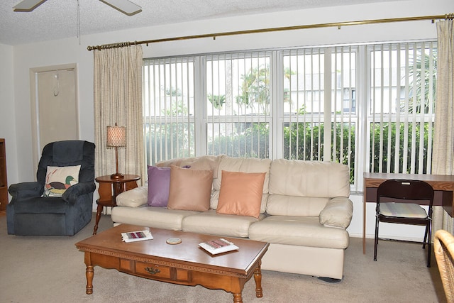 living room with light carpet, a textured ceiling, and ceiling fan