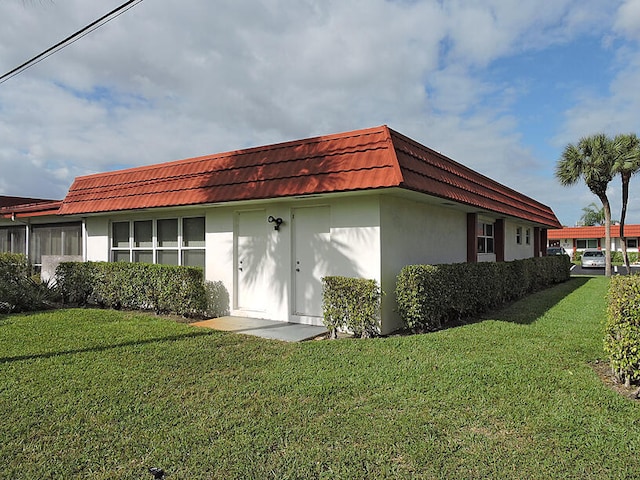 back of property featuring a yard