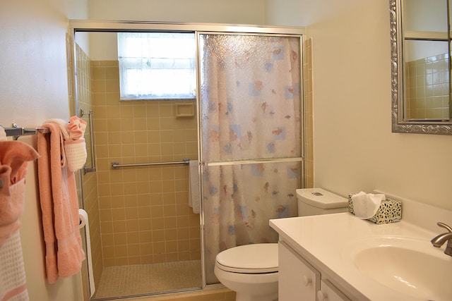 bathroom featuring vanity, toilet, and an enclosed shower