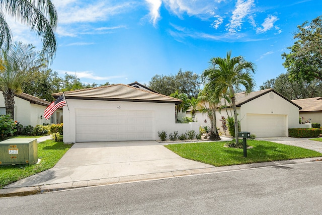 ranch-style home with a front yard and a garage