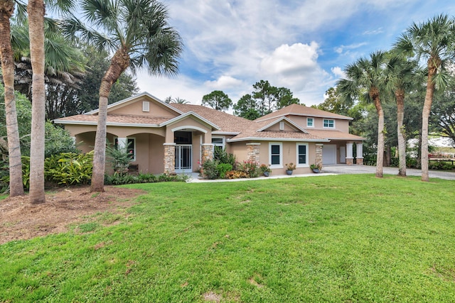 view of front of property featuring a garage and a front lawn