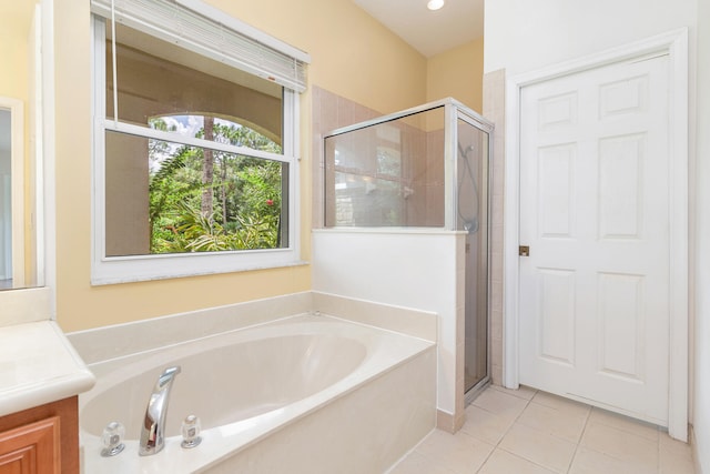 bathroom featuring shower with separate bathtub, tile patterned flooring, and vanity